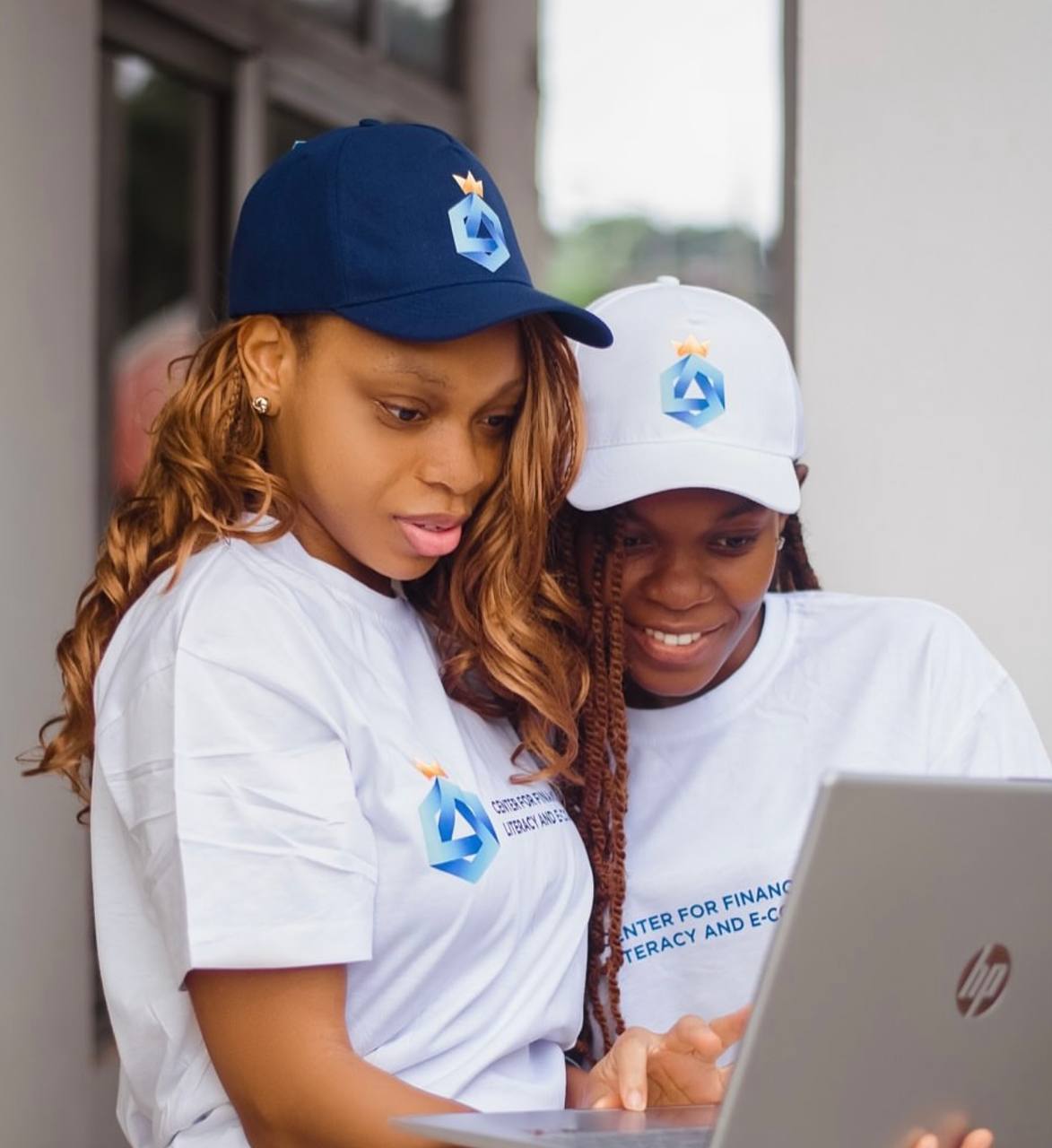 CFLECD team members reviewing platform work on a laptop